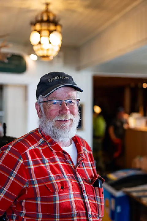 Portrait of a man wearing glasses and a hat