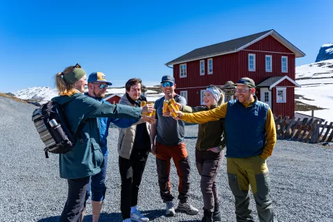 Group of people in the mountains, cheering with Solo lemonade